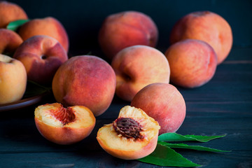 Ripe and tasty peaches on a wooden table