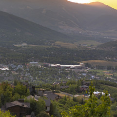 Sunset behind mountains with homes in front