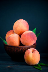 Fototapeta na wymiar Ripe and tasty peaches on a wooden table