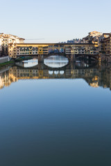 Obraz premium Famous bridge Ponte Vecchio over Arno river at sunset in Florence, Tuscany, Italy