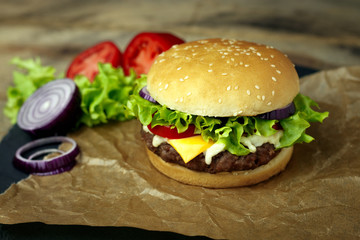Delicious fresh homemade burger on a wooden table