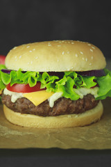 Delicious fresh homemade burger on a wooden table