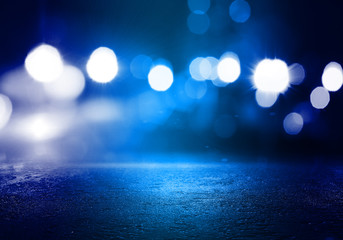 The background of an empty room with a concrete floor and blurred neon lights. Abstract blue...