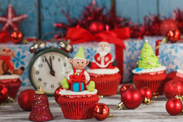 Christmas cupcakes with colored decorations, soft focus background