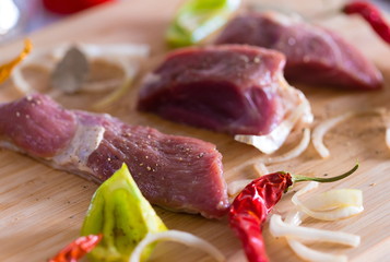 Food. pieces lamb, peppers and onions, wooden board