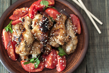 Grilled chicken wings with sesame seeds on a plate