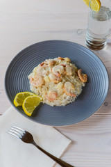 Shrimp in cream sauce with rice and lemon