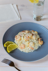 Shrimp in cream sauce with rice and lemon