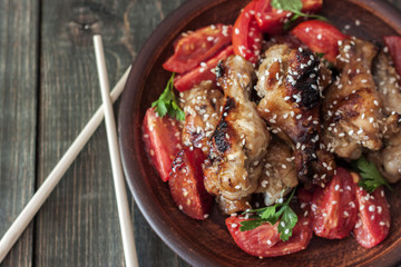 Grilled chicken wings with sesame seeds on a plate
