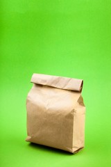 Brown Paper Bag on Green Background