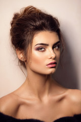 Naklejka premium Portrait of beautiful young brunette woman with makeup