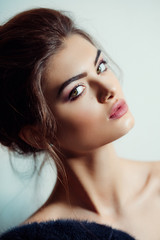 Fototapeta premium Portrait of beautiful young brunette woman with makeup