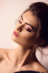 Obraz premium Portrait of beautiful young brunette woman with makeup