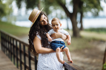 Fototapeta premium Amazing young mother with little son in the park 