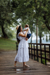 Amazing young mother with little son in the park 