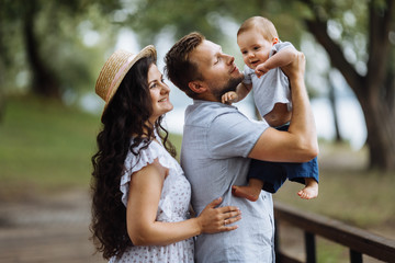 Fototapeta premium Amazing young couple with small son in the park