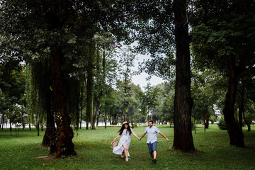 Pretty couple in the forest at summer 