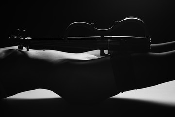 violin on the background of a beautiful naked female body