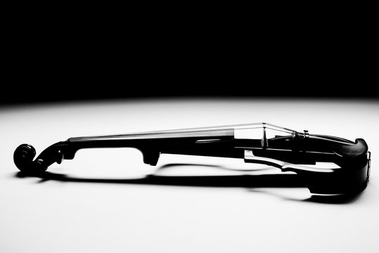 Electric violin stands on a white background