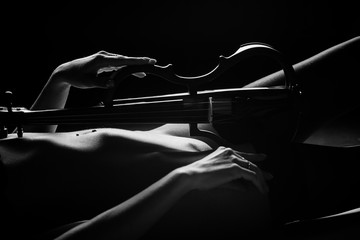 violin on the background of a beautiful naked female body