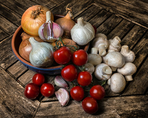 An arrangement of healthy fresh raw food on a wooden background.