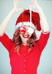 Beautiful happy young woman in a santa claus costume with perfect make up, red lipstick and...