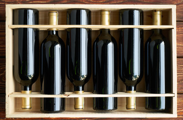 Wine bottles collection in wood box. Top view of a case of cabernet sauvignon wine bottles