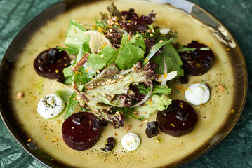 Beet Salad with Goat Cheese, Candied Walnuts, Spring Greens, and Herbs. Healthy diet  and...