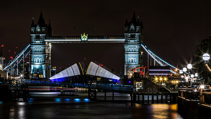 Fototapeta na wymiar Tower Bridge in London UK at night taken as a long exposure to show the movement of the bridge.