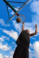 Low Angle View of Basketball Player Dunking Ball © BillionPhotos.com