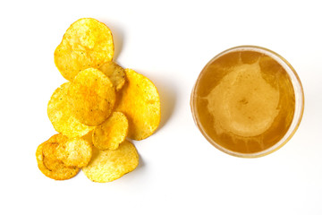 A glass of beer and potato chips on a white background.