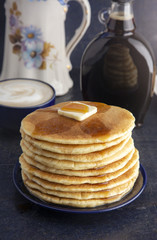 Stack of Freshly Made American Style Pancakes with Metling Butter