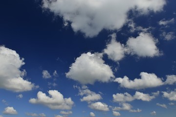 Obraz premium Pleasant sky, Jersey, U.K. Fluffy white clouds with a blue sky.