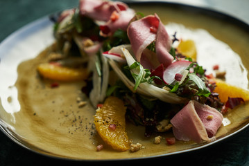 Healthy diet salad with Smoked duck breast, Candied Walnuts, Spring Greens, Orange and Herbs. Smoked duck breast with fresh vegetable salad
