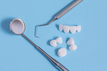 Dental tools with samples of zircon dentures - Ceramic veneers - lumineers