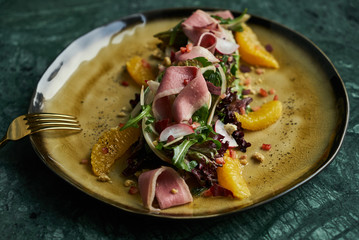 Healthy diet salad with Smoked duck breast, Candied Walnuts, Spring Greens, Orange and Herbs. Smoked duck breast with fresh vegetable salad