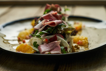 Fresh vegetable salad with Smoked duck breast. Healthy diet salad with smoked duck, Candied Walnuts, Spring Greens, Orange and Herbs