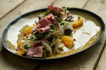 Fresh vegetable salad with Smoked duck breast. Healthy diet salad with smoked duck, Candied Walnuts, Spring Greens, Orange and Herbs