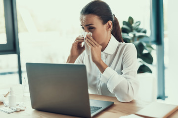 Young Sick Woman in White Shirt Sitting in Office.