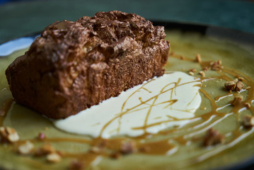 Chocolate dessert fondant with a liquid and pistachio ice cream, close-up