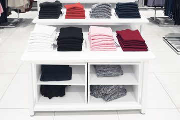 Women's sweaters on the counter in the store