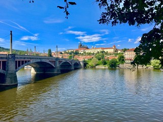 Fototapeta premium Bridge over the Vltava river with Prague castle in the Background