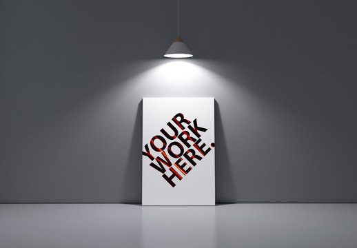 Poster Leaning Against Gray Wall Under Lamp Mockup