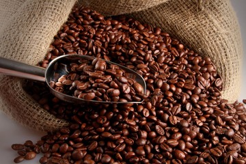 Coffee Beans With Scoop Falling Out Of Sack Close-up