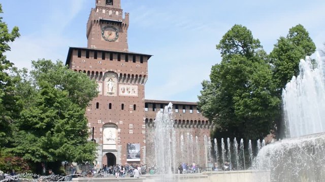Milan, Italy - Fountain la turta di spus - pedestrian walking by to Castle