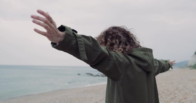 Millennial female feeling carefree on a winter beach