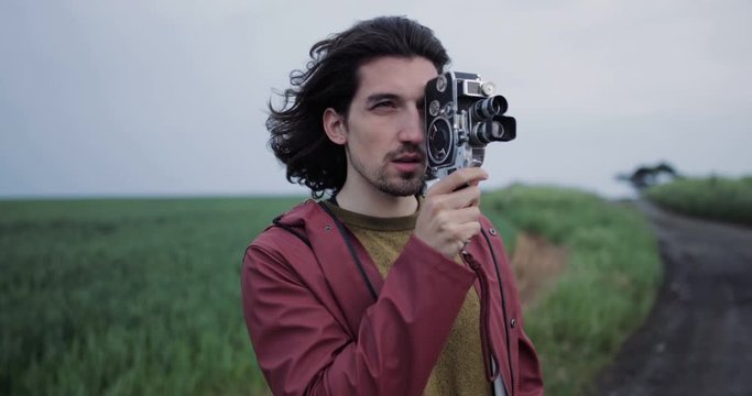 Millennial male using vintage 8mm film camera