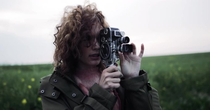 Millennial female using vintage 8mm film camera