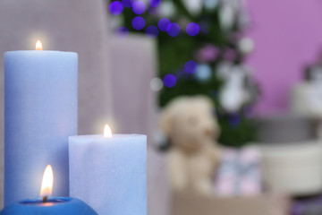 Burning candles in living room. Stylish Christmas interior