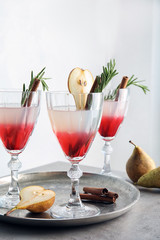 Tasty refreshing pear cocktail with rosemary on table